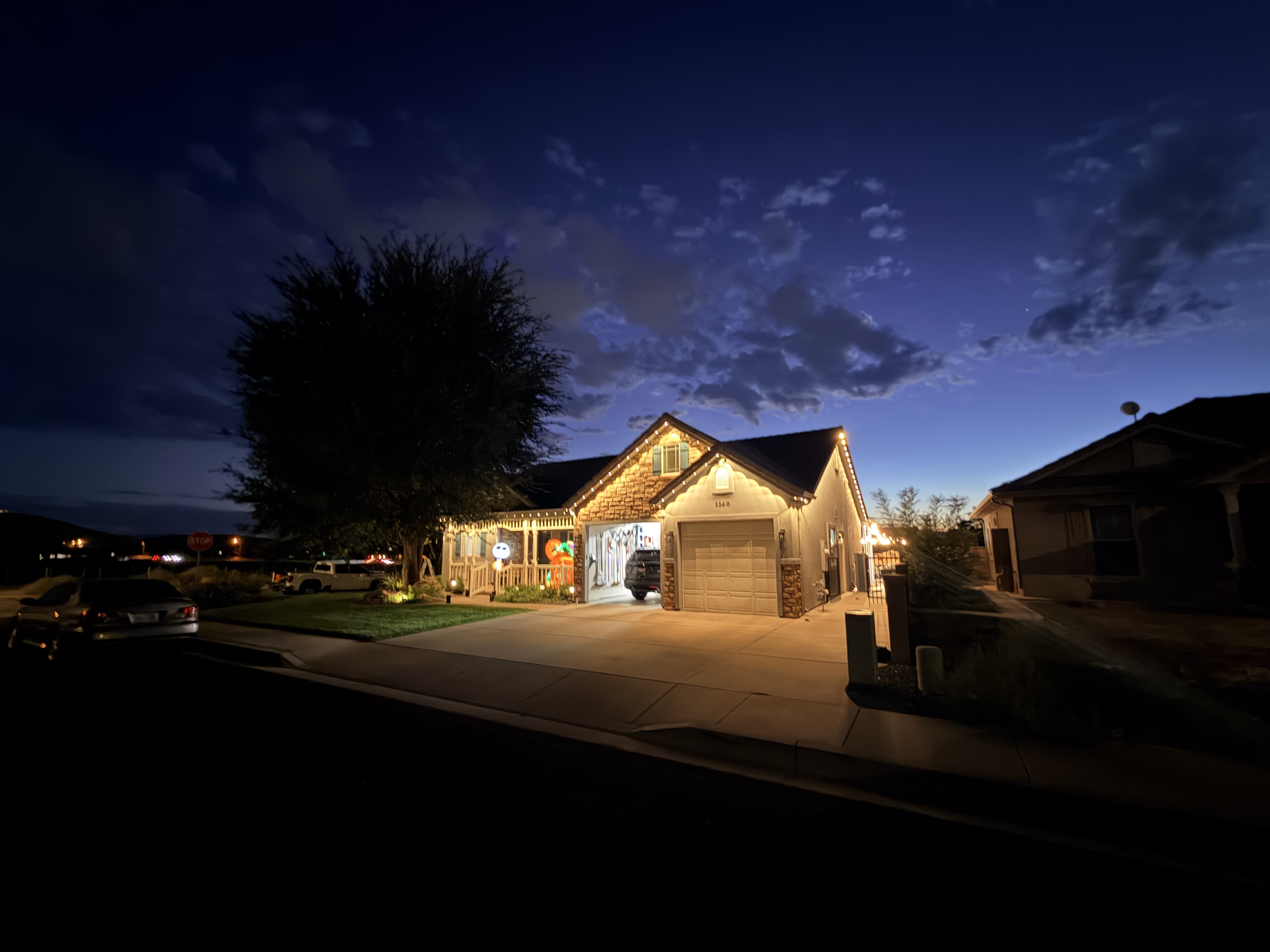 Eddys Solutions permanent lighting installation glowing warm white along the eaves at dusk